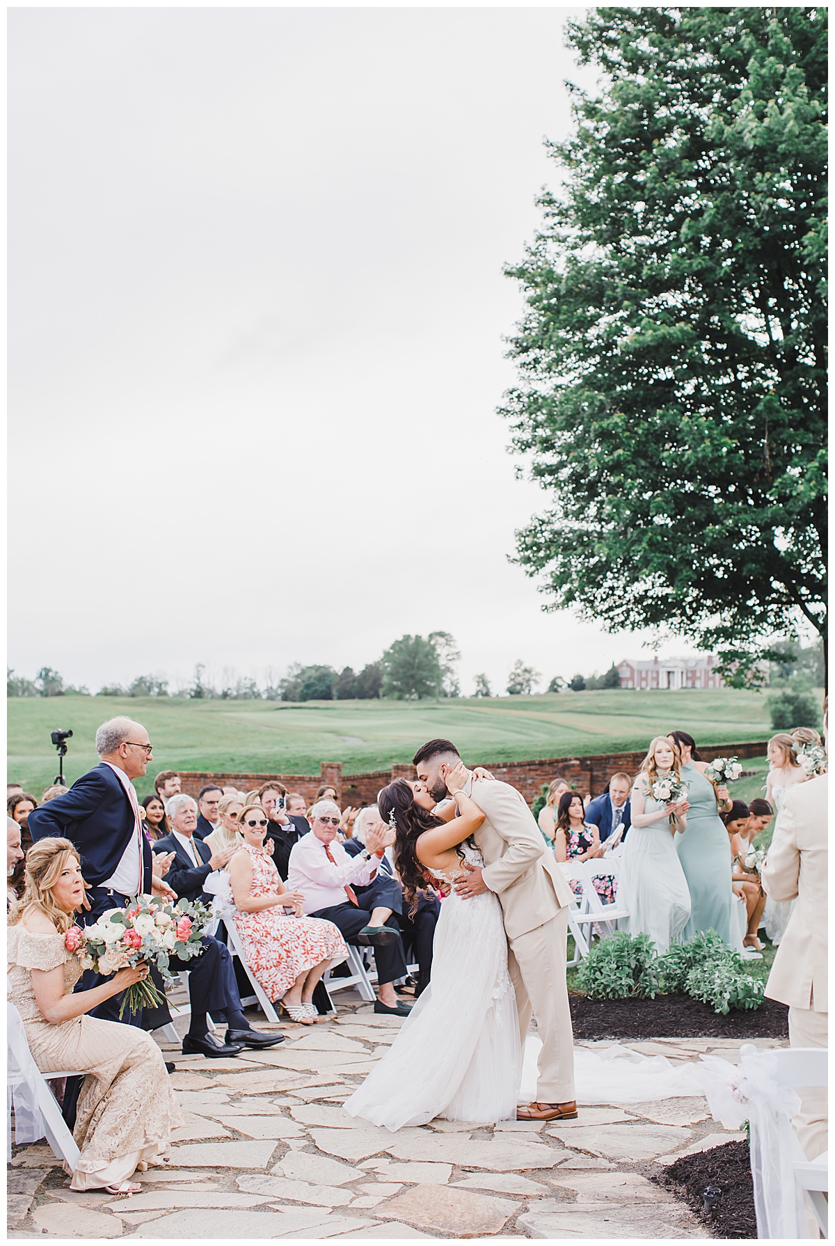 bride and groom kissing for first time at Hamilton farm golf club