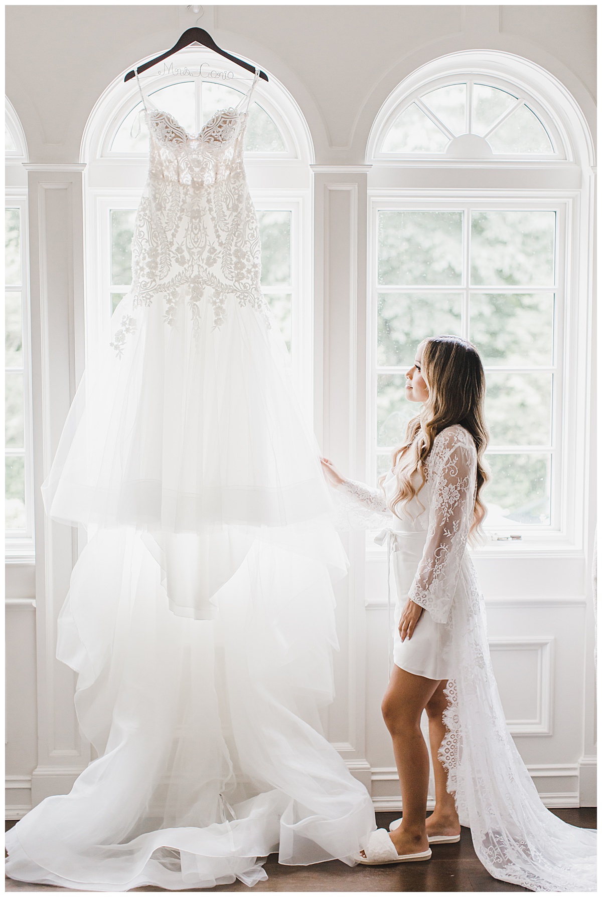 bride looking up at dress 