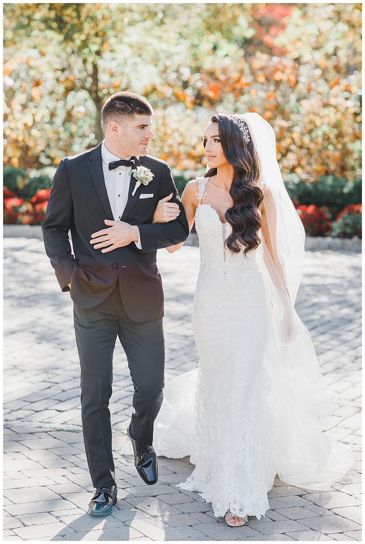 bride and groom walking and looking at each other 