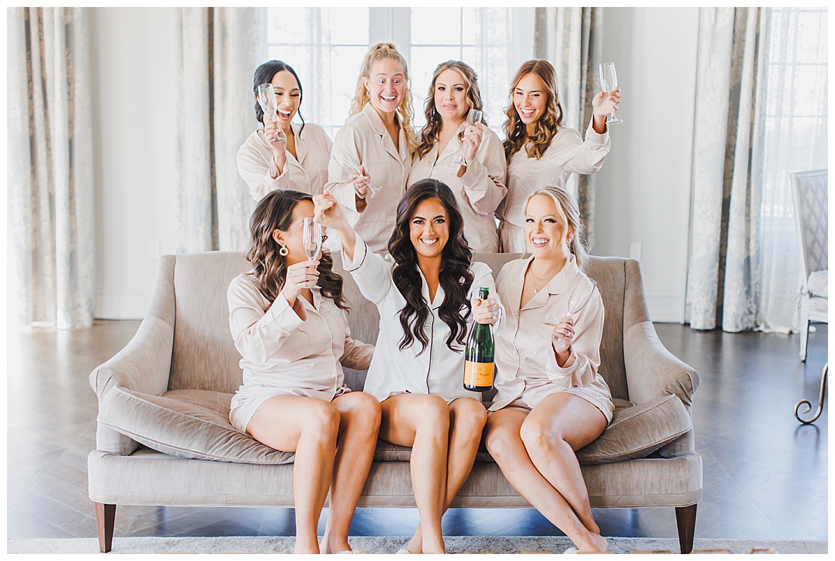 bride and bridesmaids popping champagne 