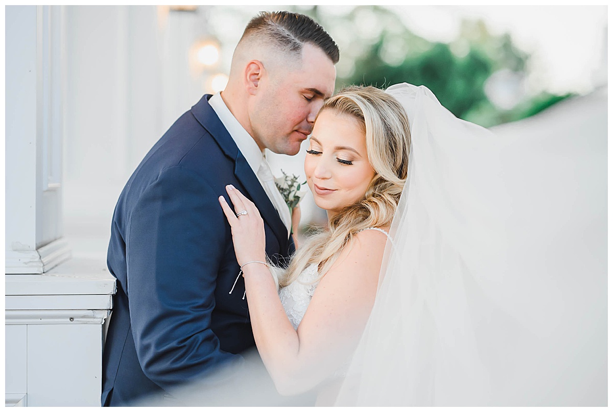 bride and groom veil swept across face 
