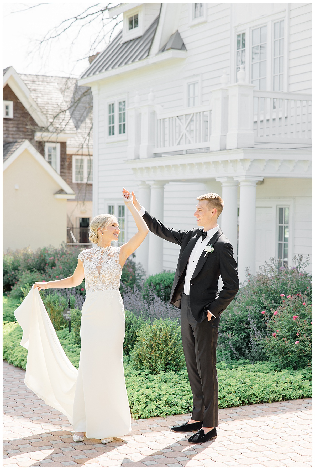 groom twirling bride in front of Ryland inn 