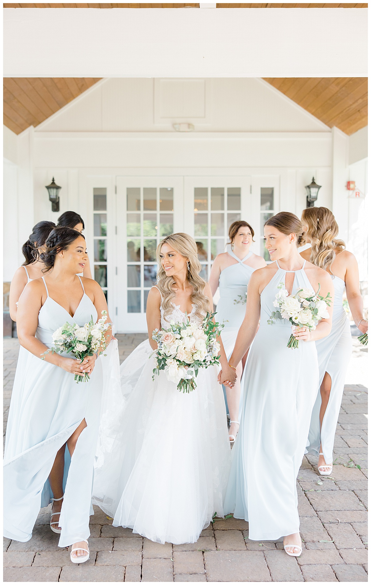 bridesmaids walking in light blue dresses 