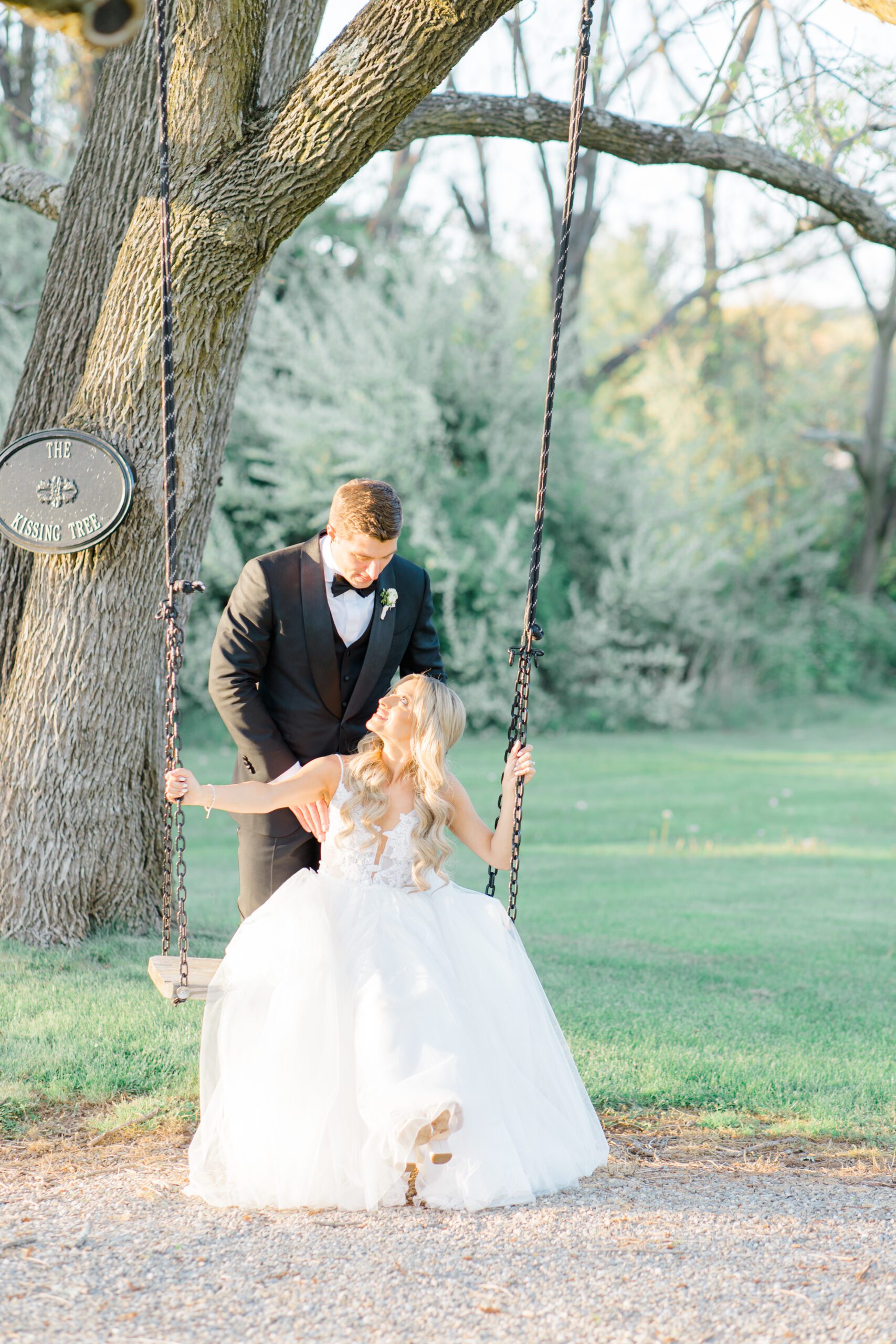bride and groom on the swing at the farmhouse nj