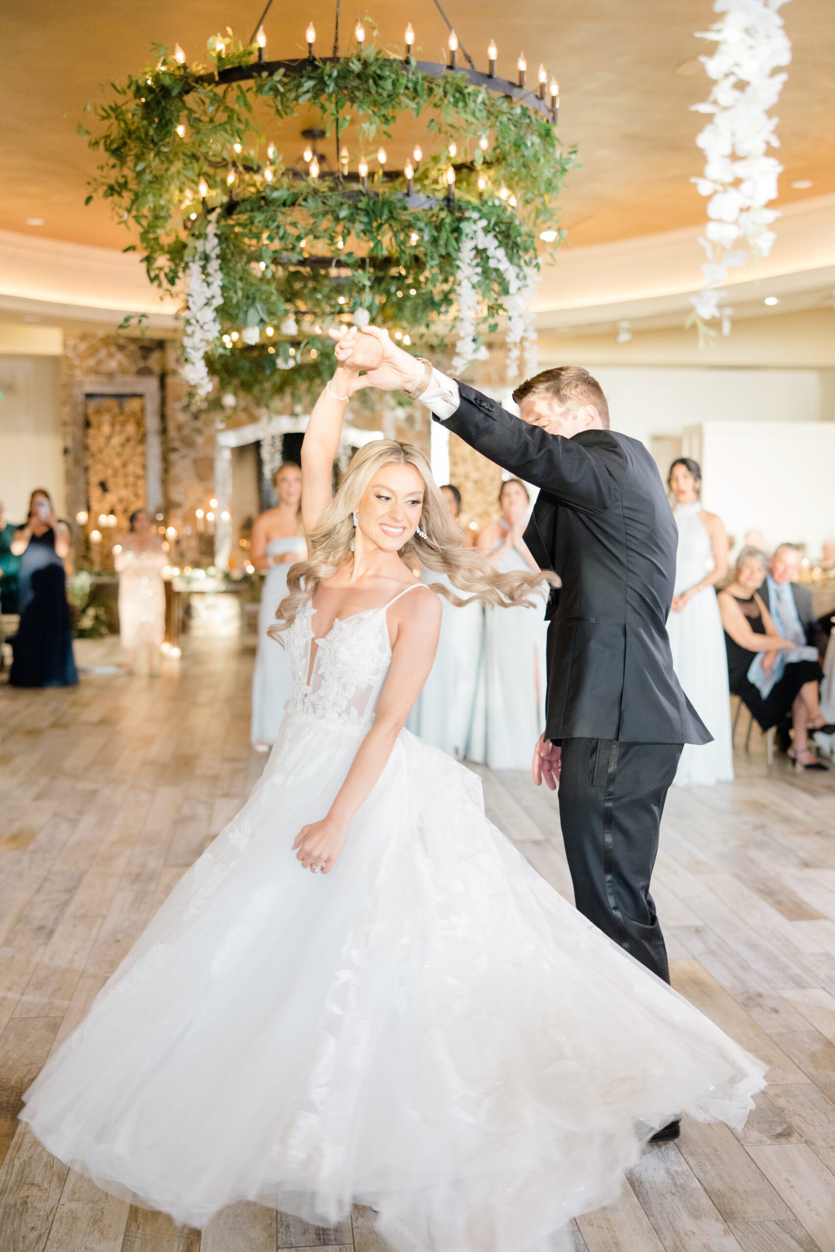 groom spinning bride on dance floor 