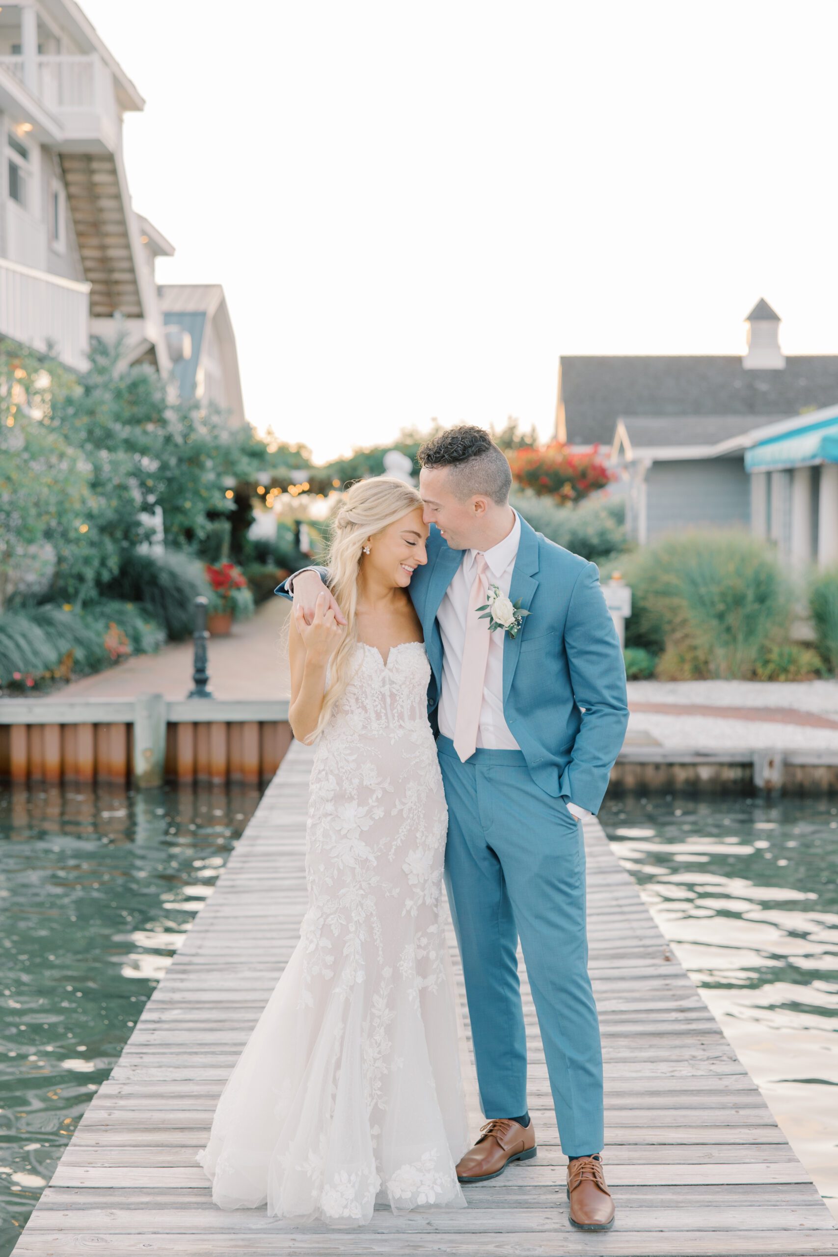 Bride and groom on dock at Bonnet Island Estate during summer wedding. 