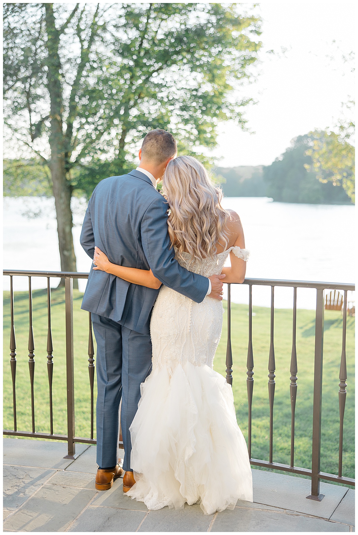 groom and bride looking at lake 