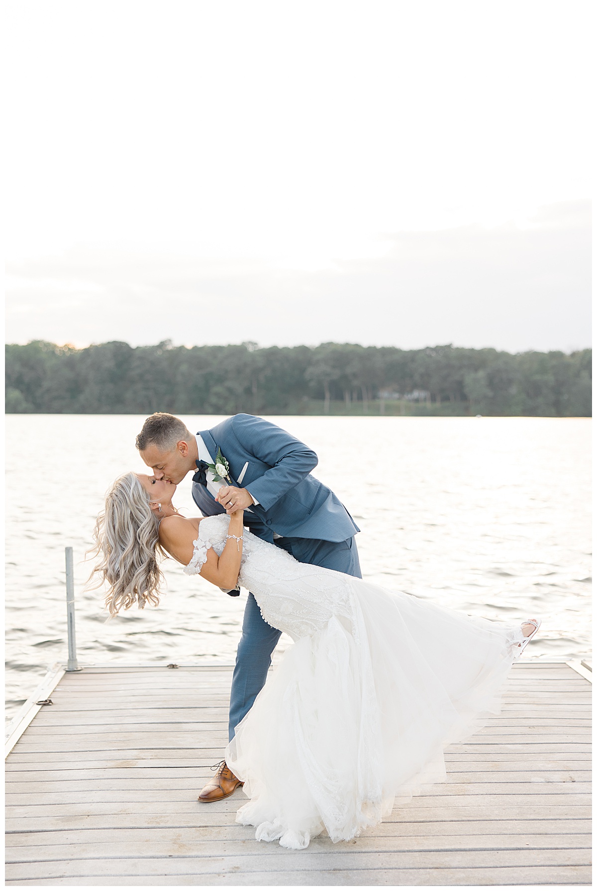 groom dipping bride on dock at Indian Trail Club 