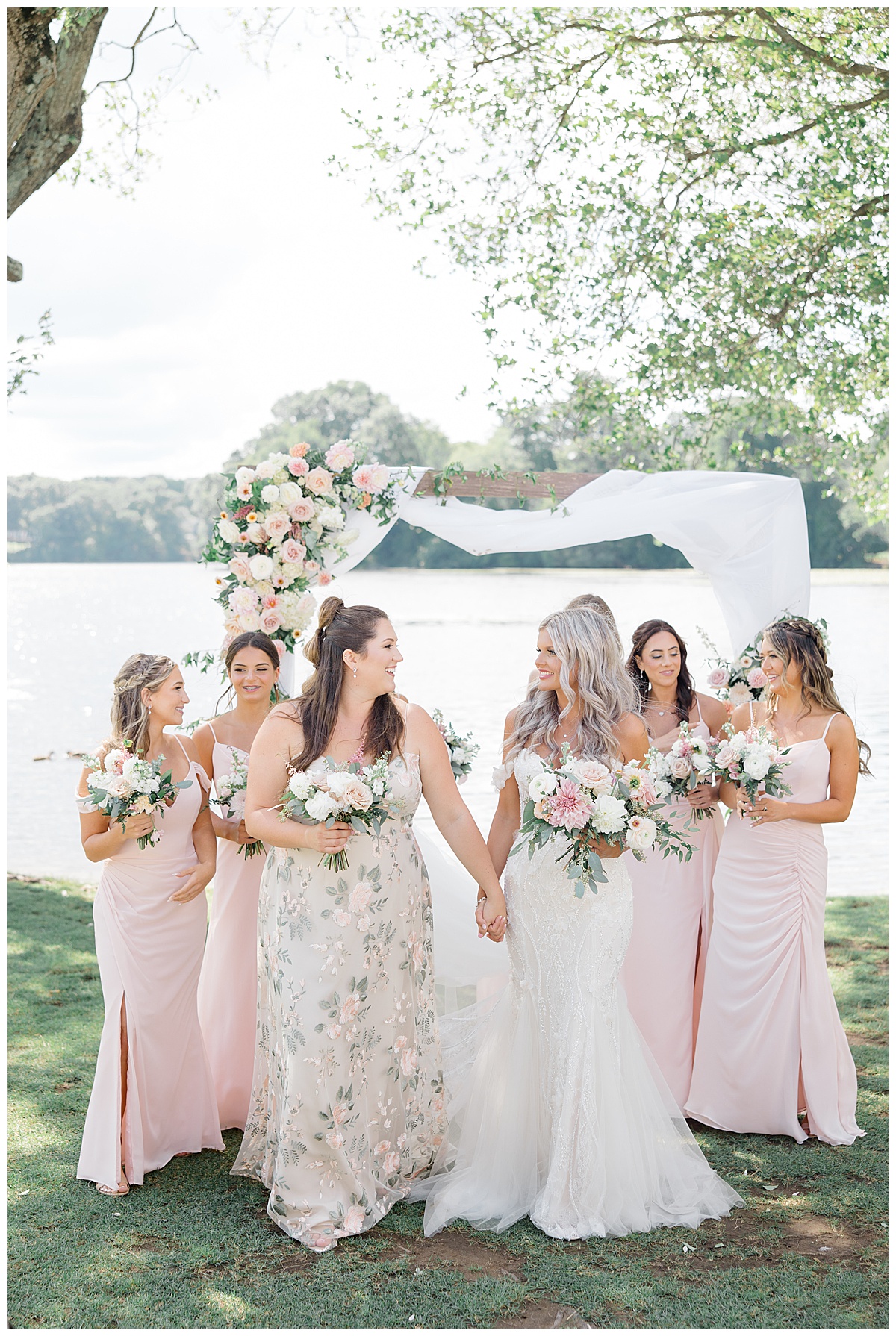 bridesmaids in blush dresses with lake behind them 