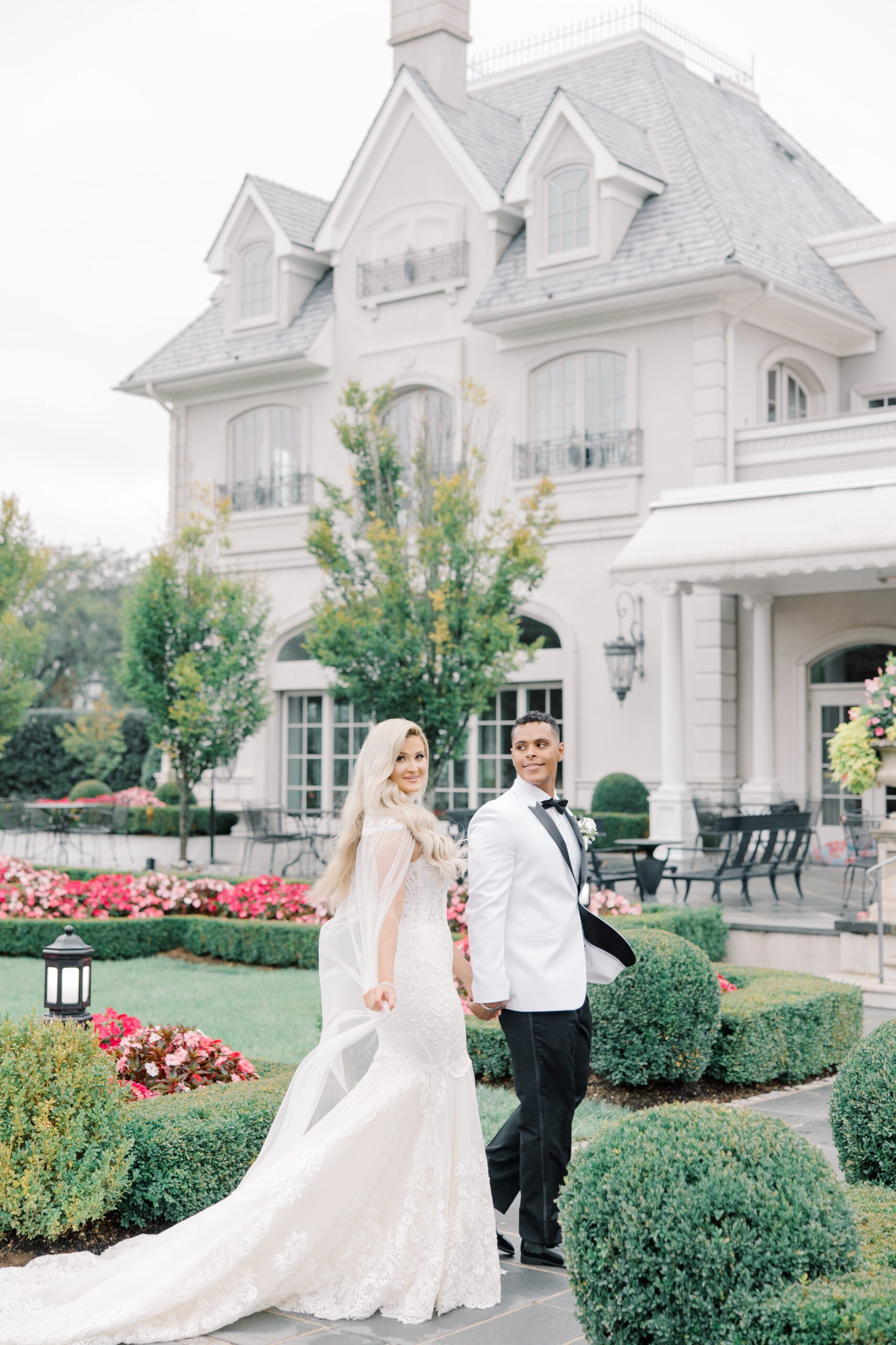 Bride and groom walking in garden at Park Chateau in East Brunswick, NJ.