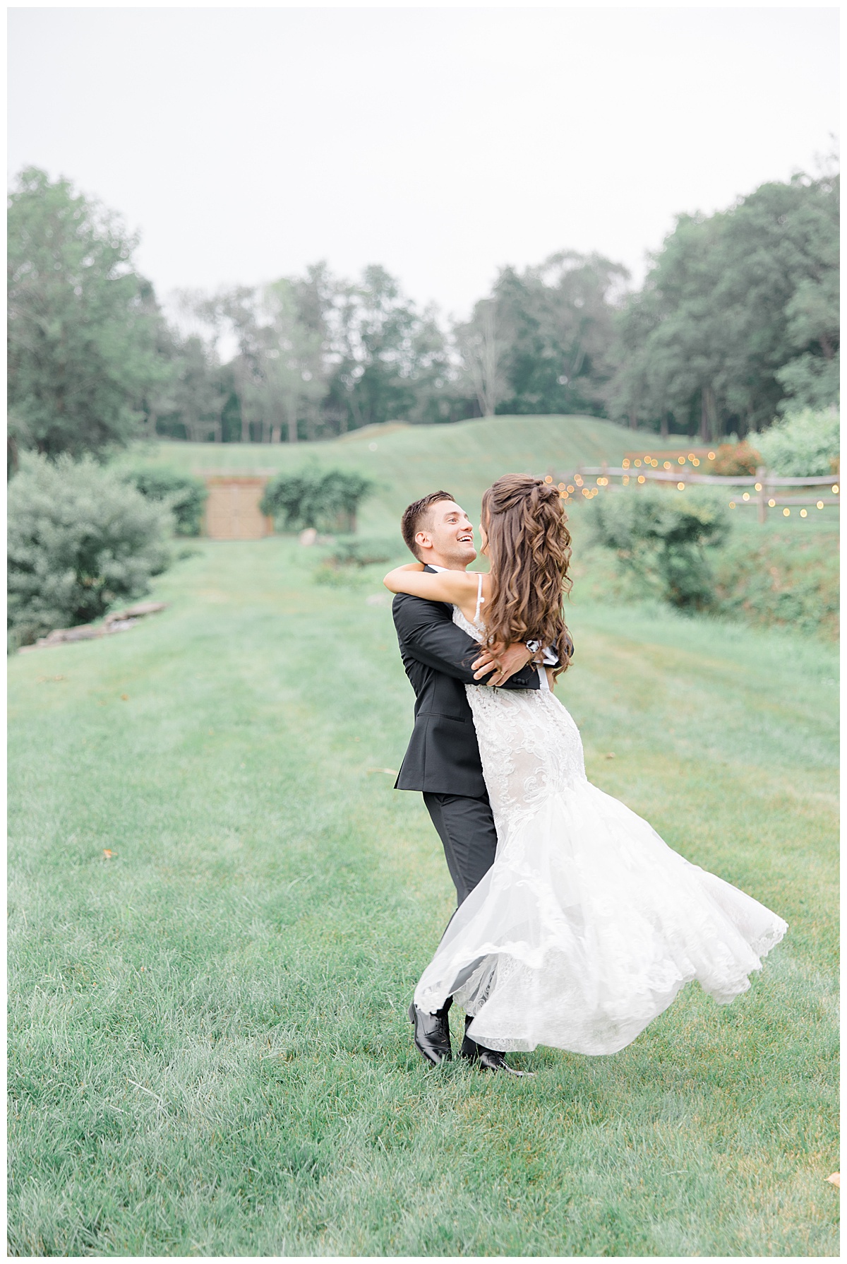 groom spinning bride in open field 
