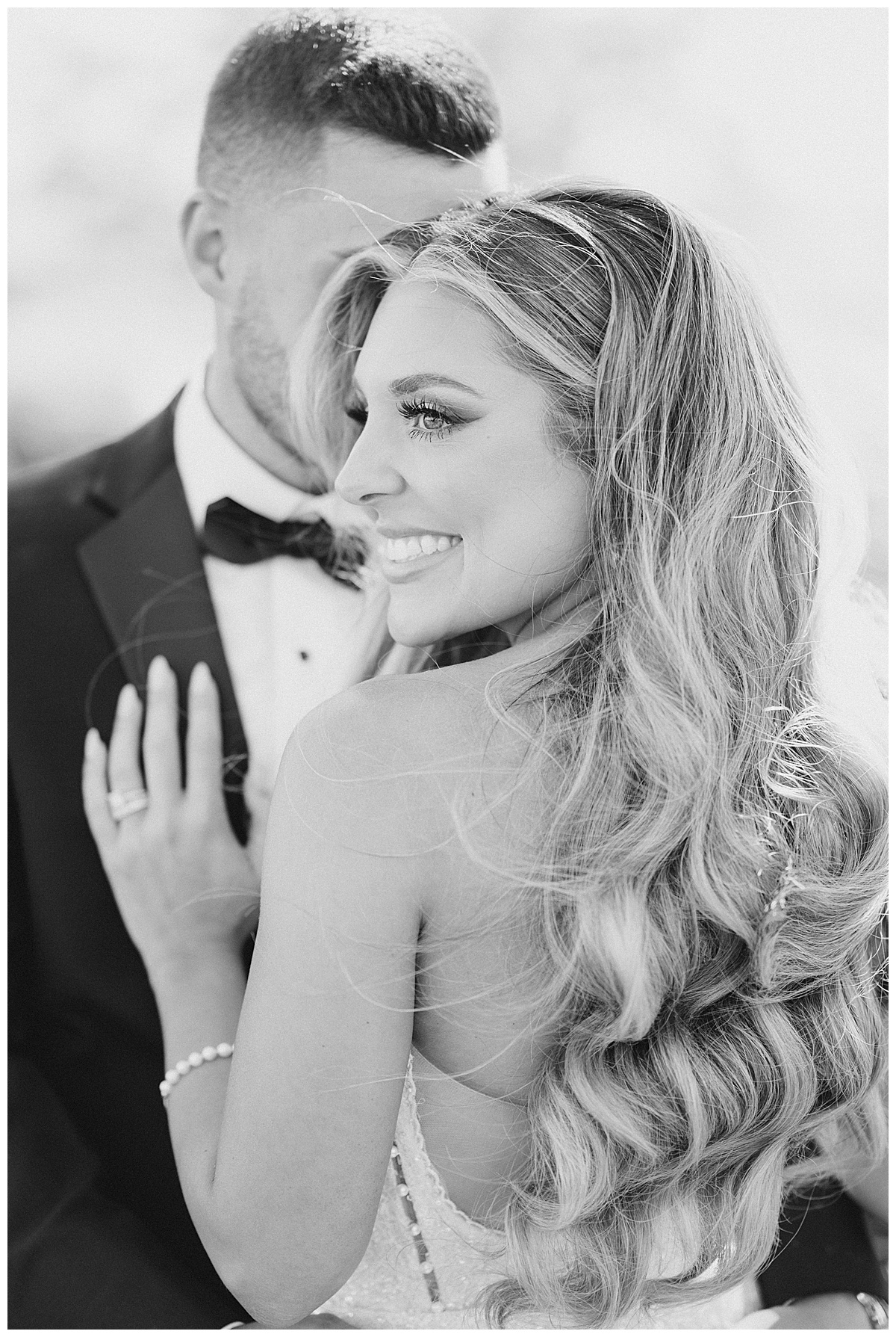 Black and white photo of bride with gorgeous soft waves for bridal hair. 