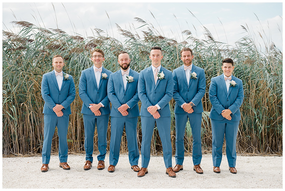 Groomsmen coastal wedding with blue suits 