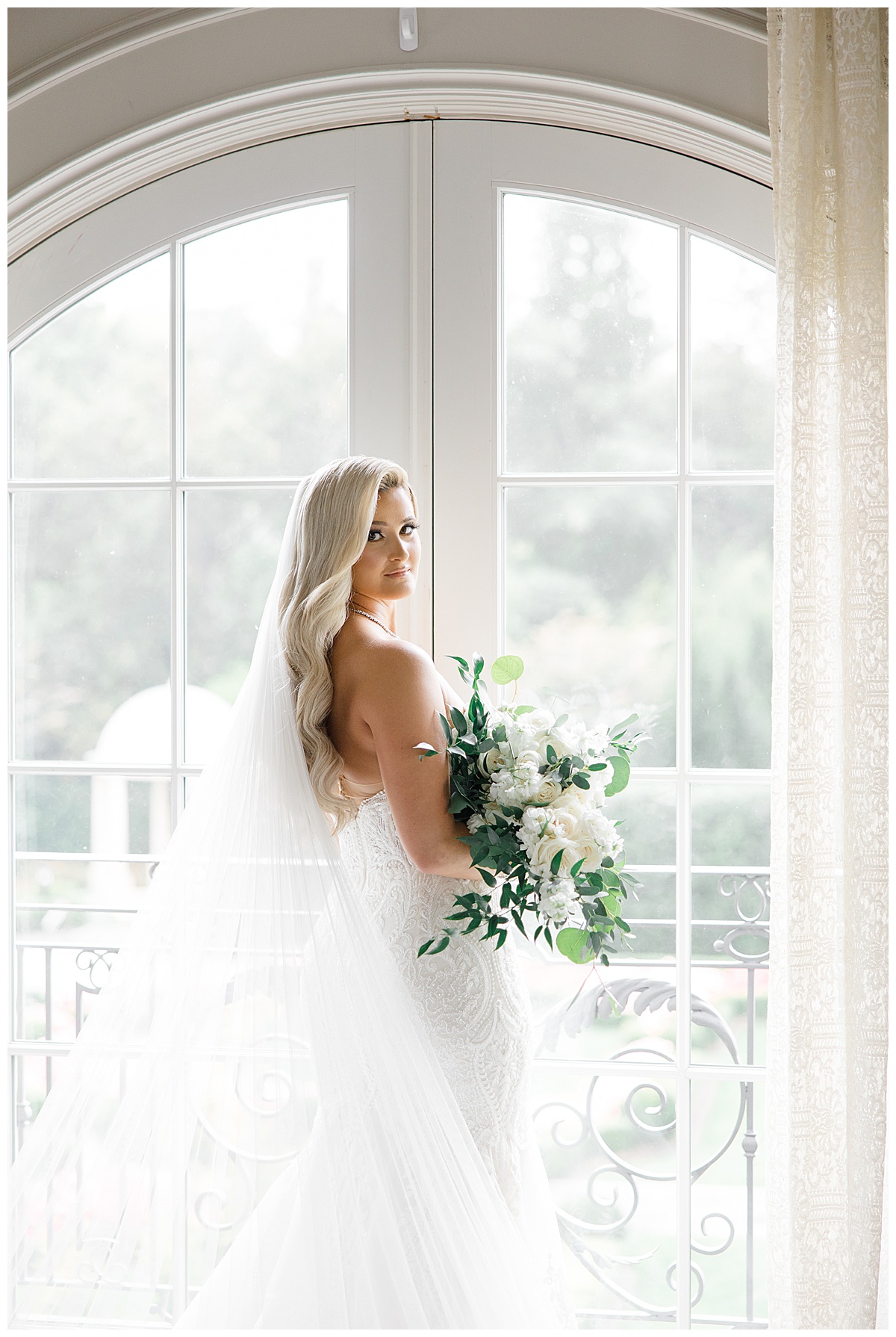 bride looking out window at park chateau 