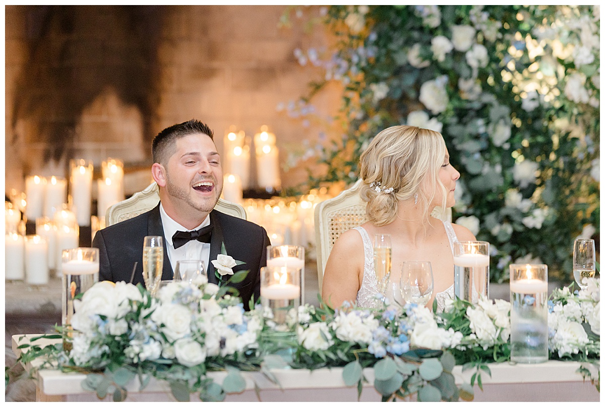 Groom laughing at wedding day toast 