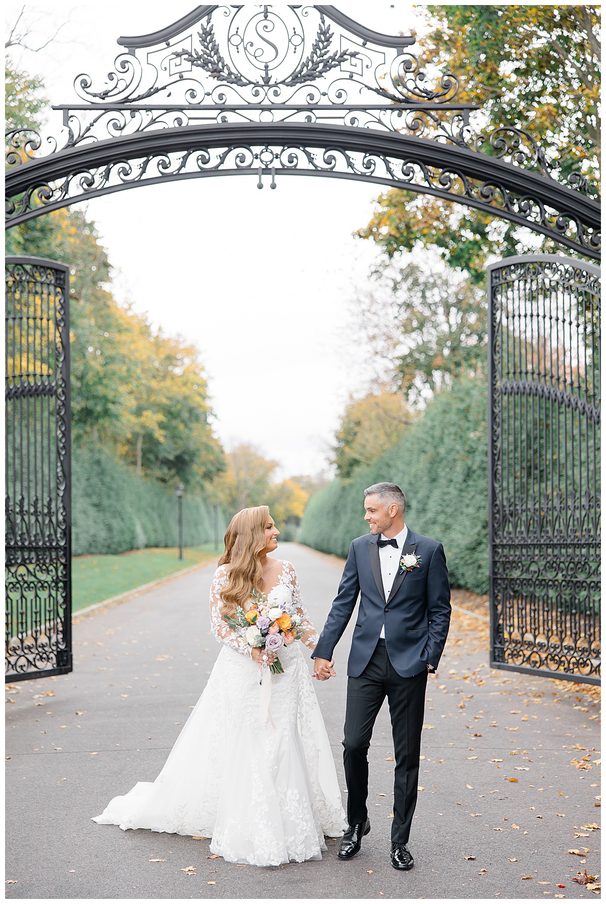 Bride and groom walking together as the gates of Shadowbrook at Shrewsbury open. 