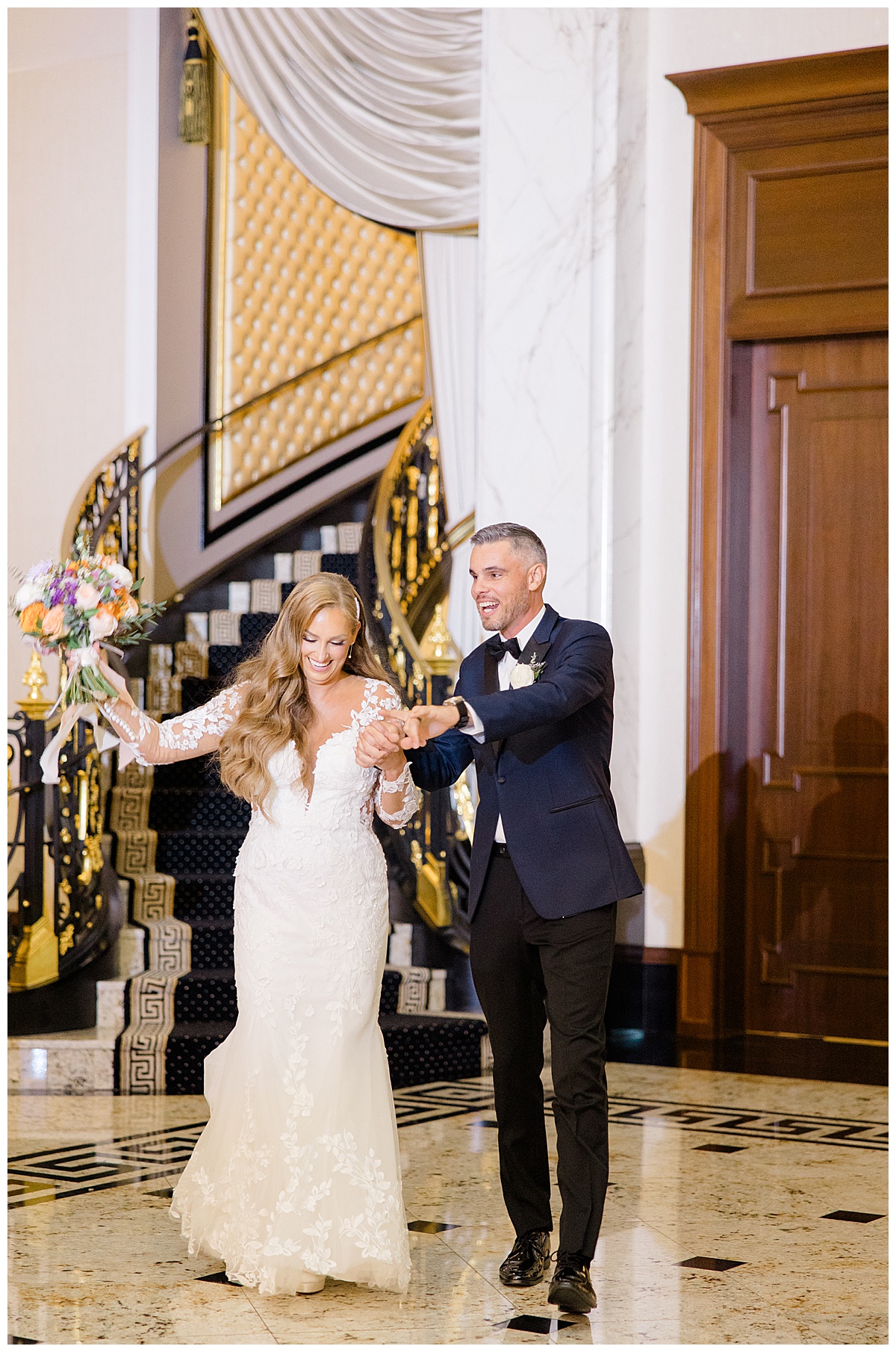 Bride and groom enter the grand ballroom using staircase at Shadowbrook at Shrewsbury. 
