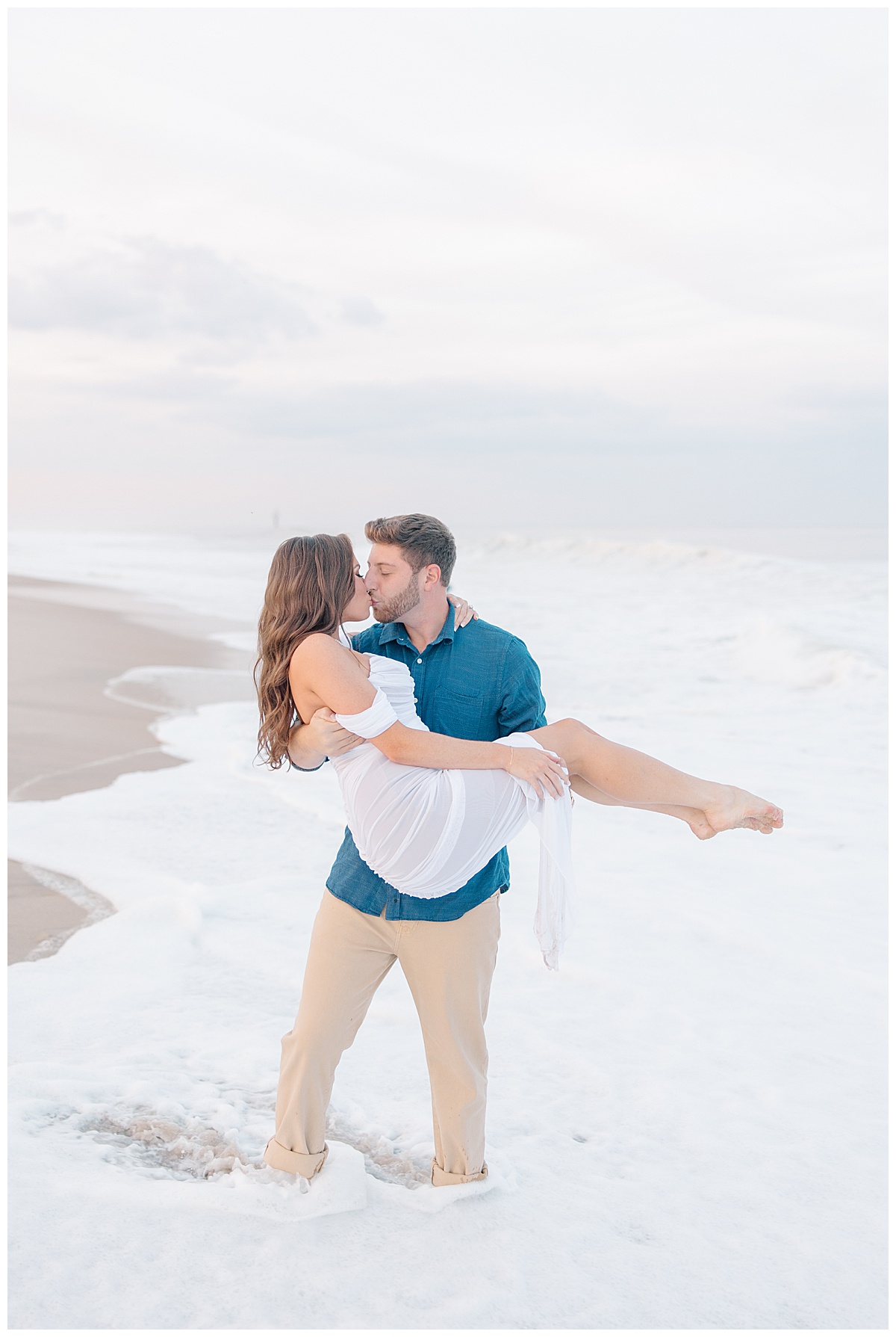 groom and bride in ocean holding each other 