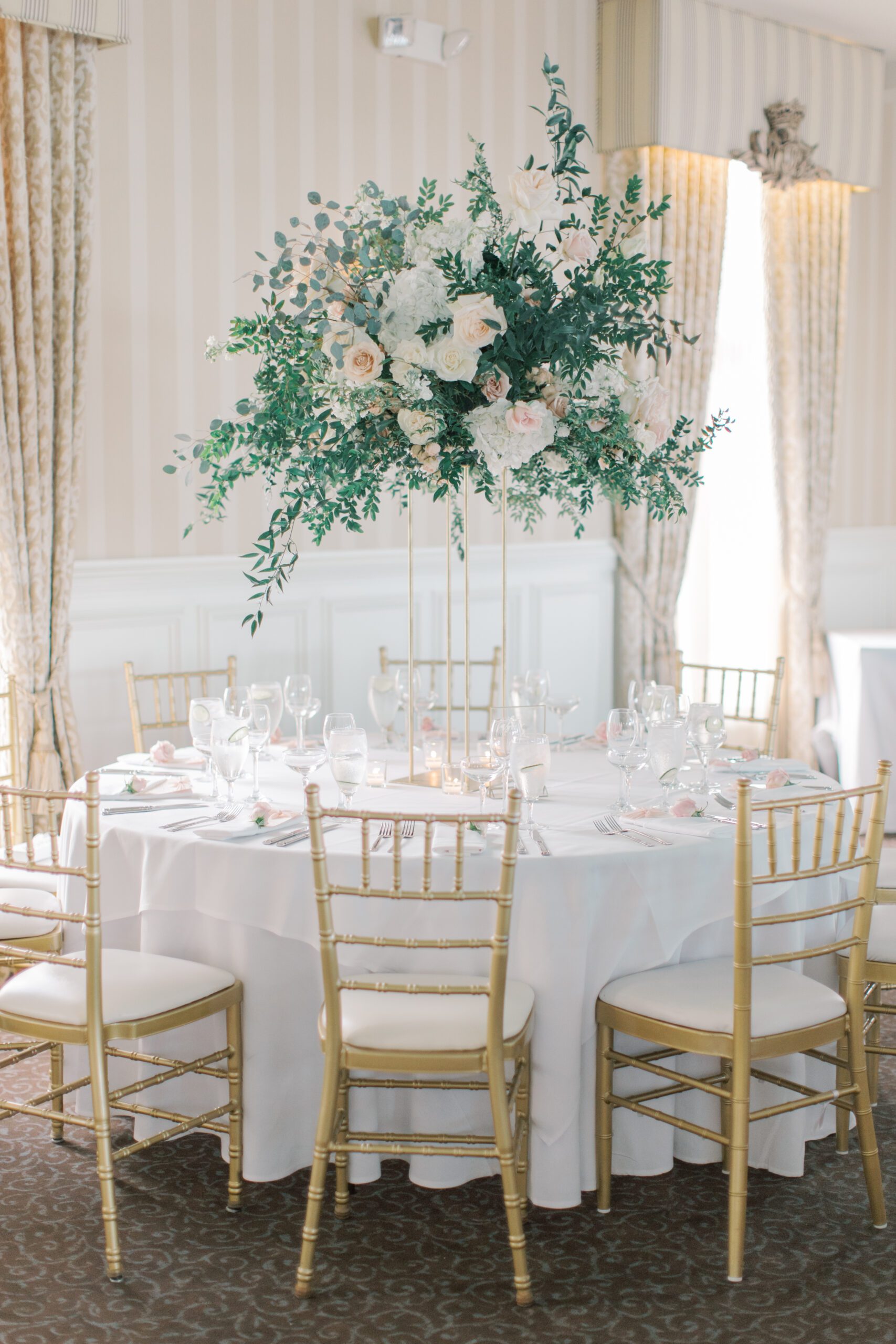 large floral centerpieces with greenery and hydrangeas. 