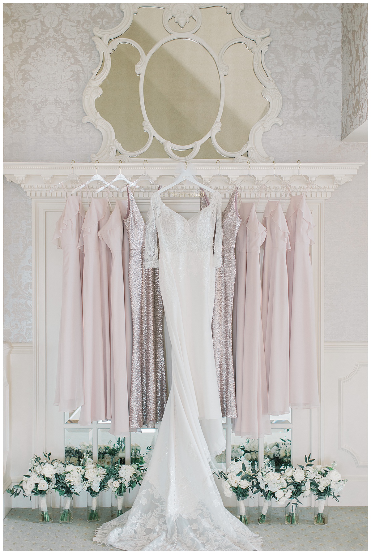 Bridesmaid dresses hung up at Mallard Island Yacht Club in the color blush with the and green floral bouquets. 