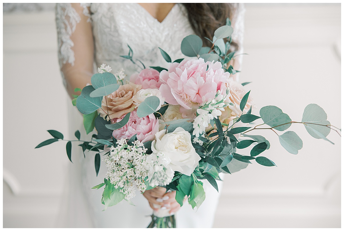 Gorgeous bouquet with pink peonies and bride in lace sleeves. 