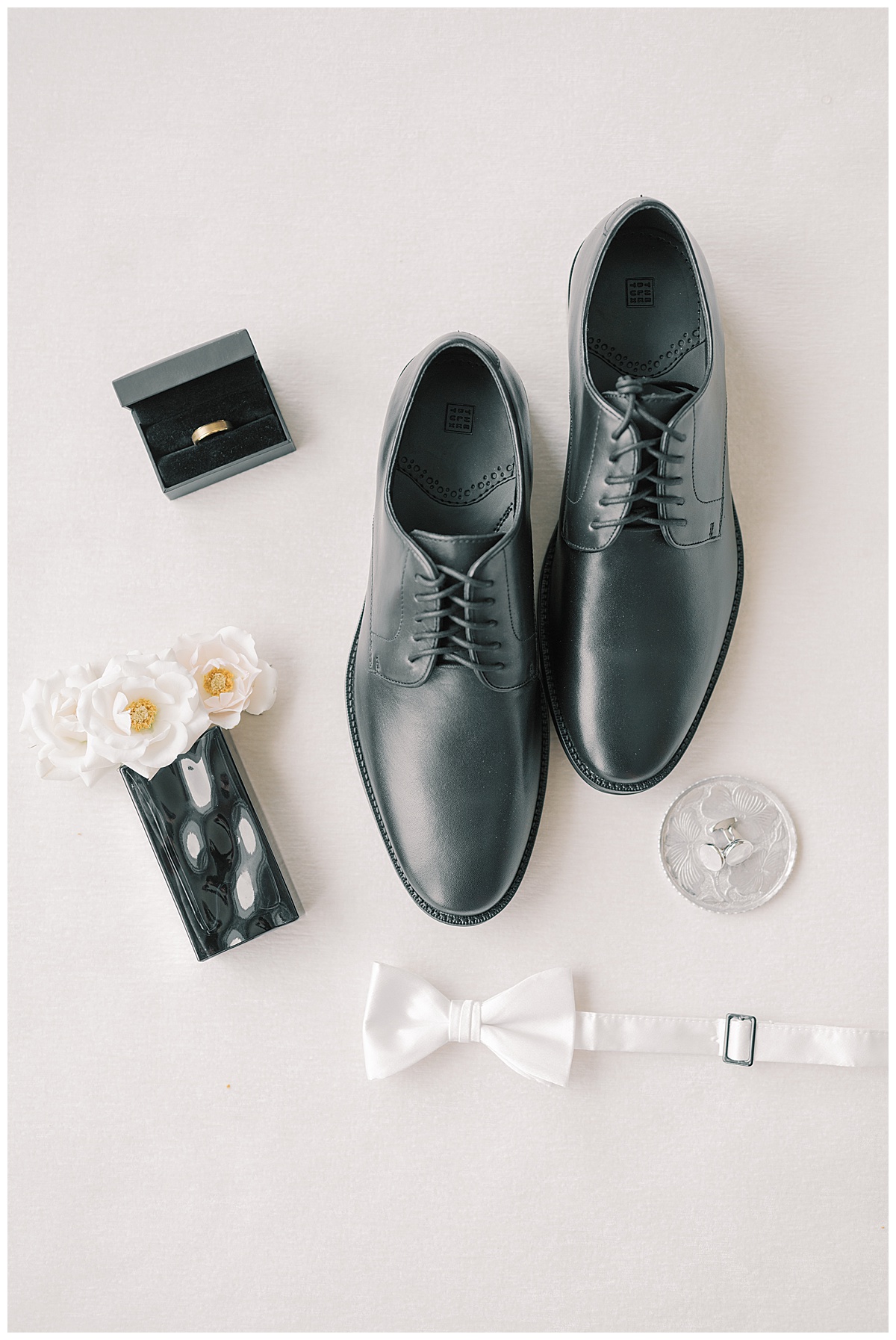 Groom details with black shoes and gold wedding band. 