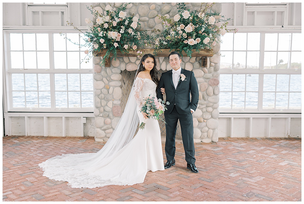 Bride and groom overlooking the water at Mallard Island Yacht Club in LBI, NJ. 