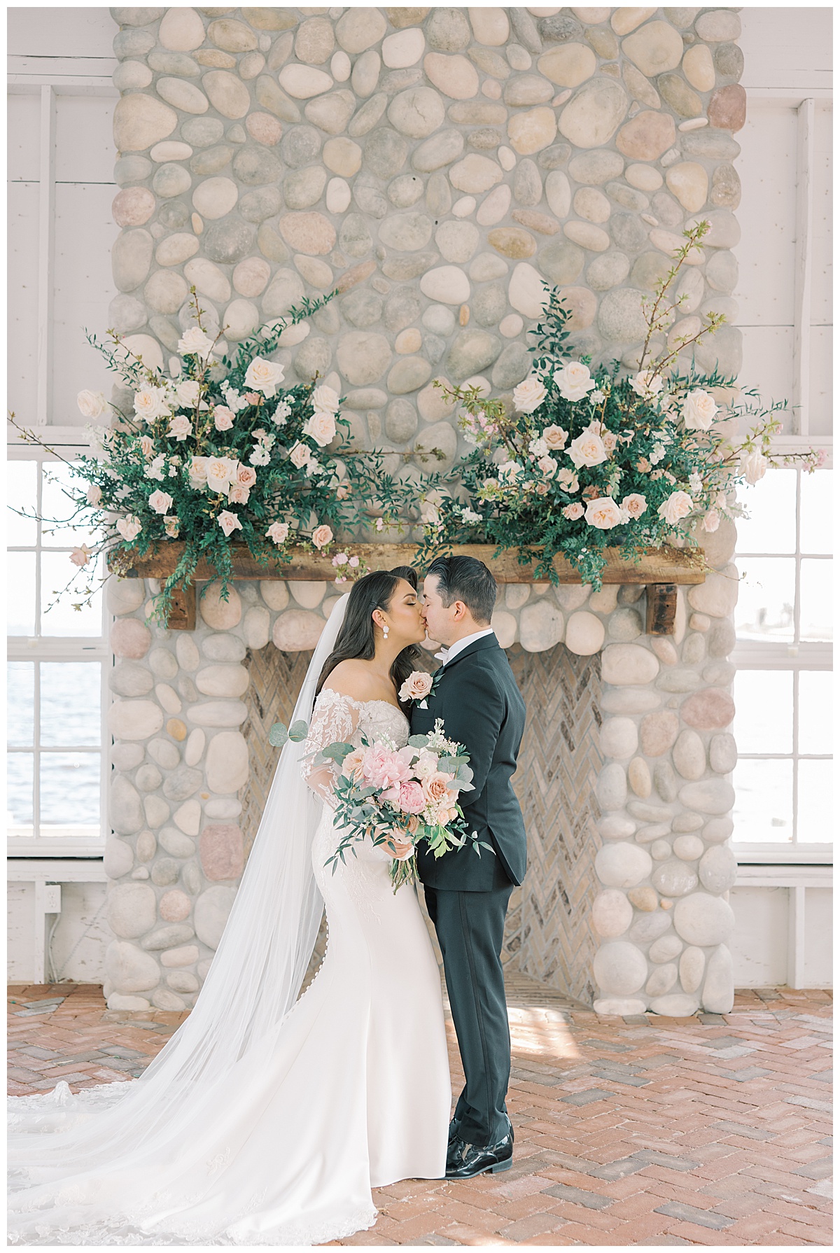 Bride and groom kiss with beautiful mantel florals at Mallard Island Yacht Club. 