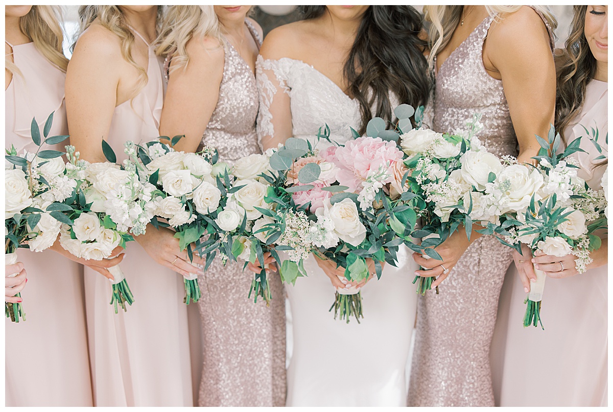 Bridesmaids bouquets with white and green florals and pink peonies. 
