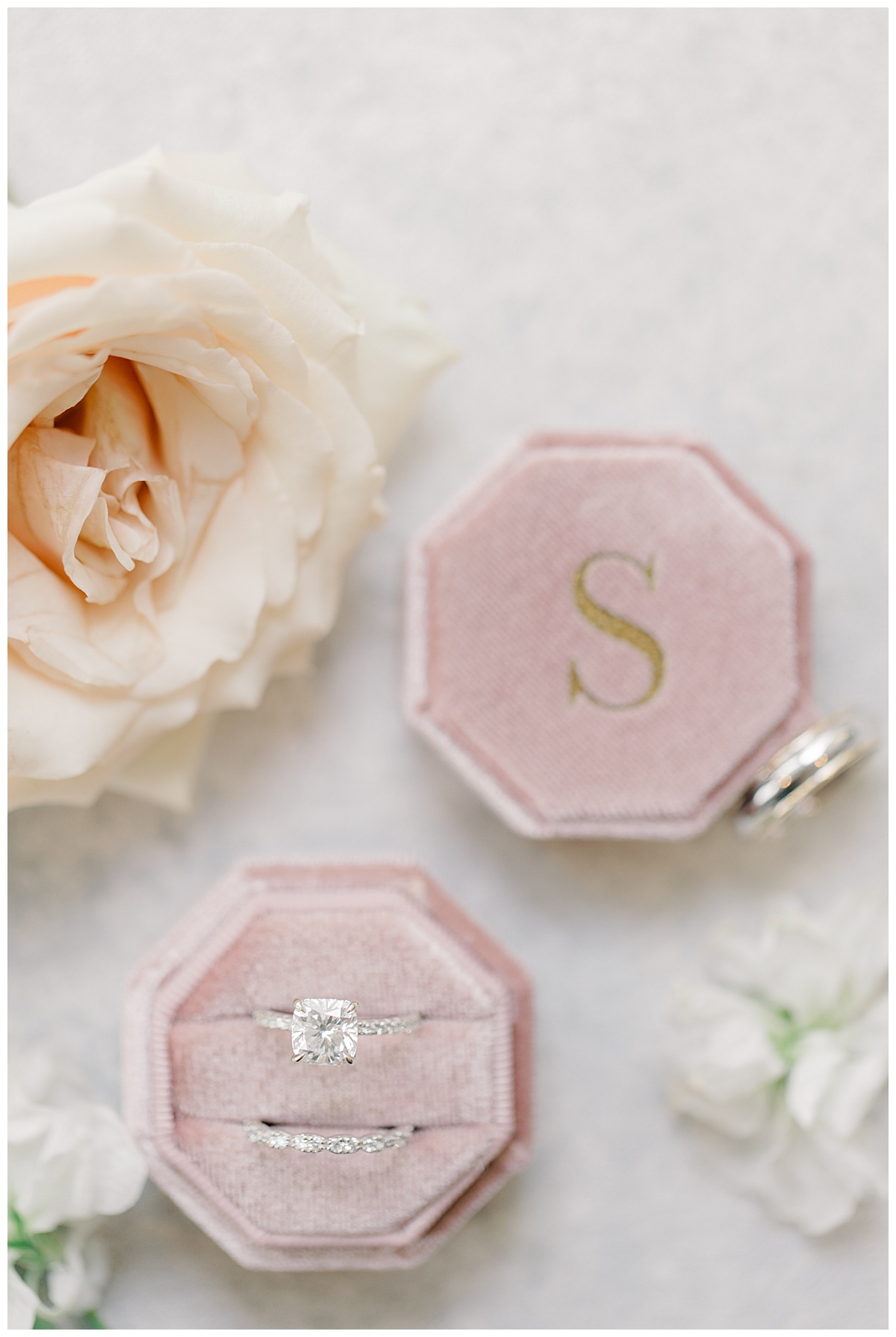 wedding rings in dusty pink velvet ring box with last name 