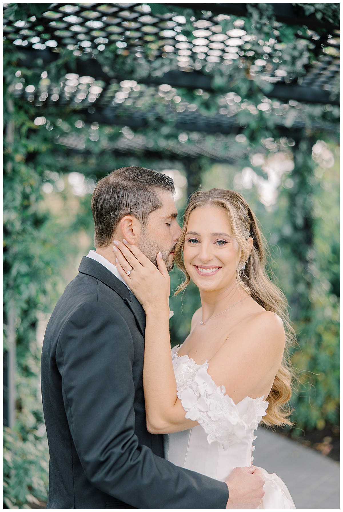 groom kissing brides temple light and airy 