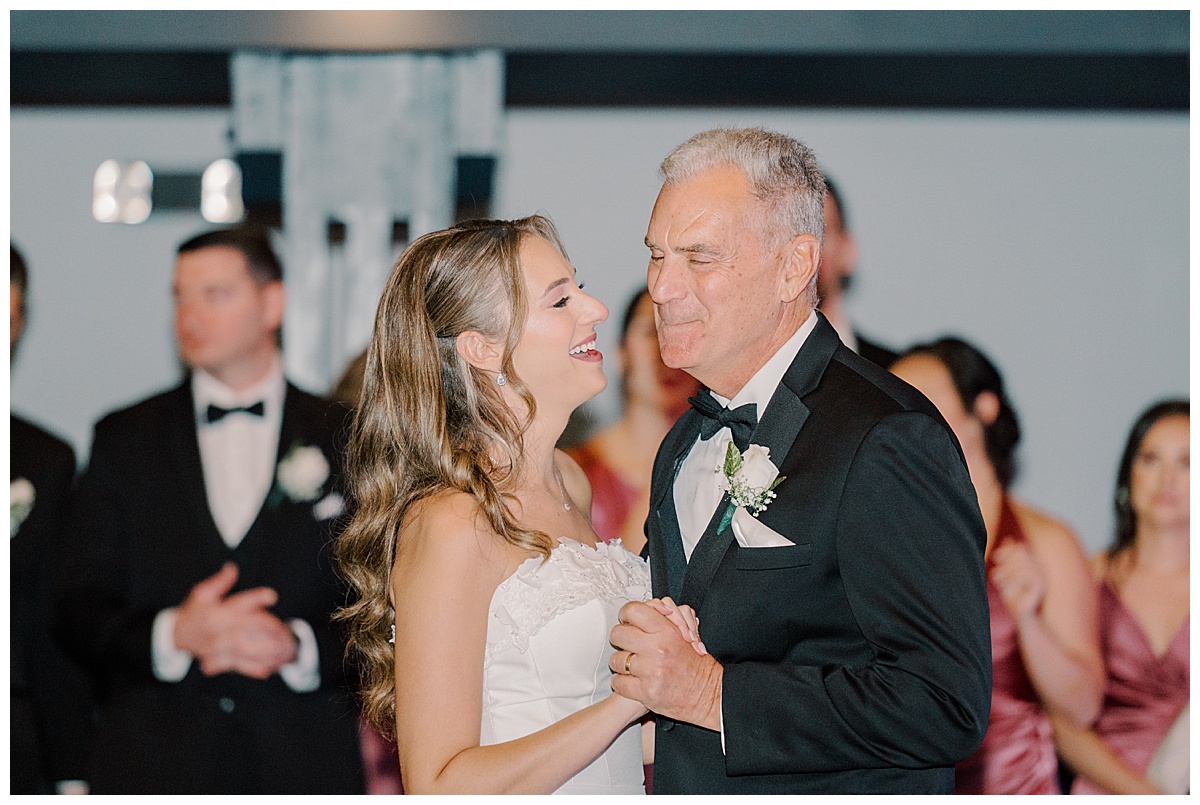 bride and father share a dance together on wedding day 