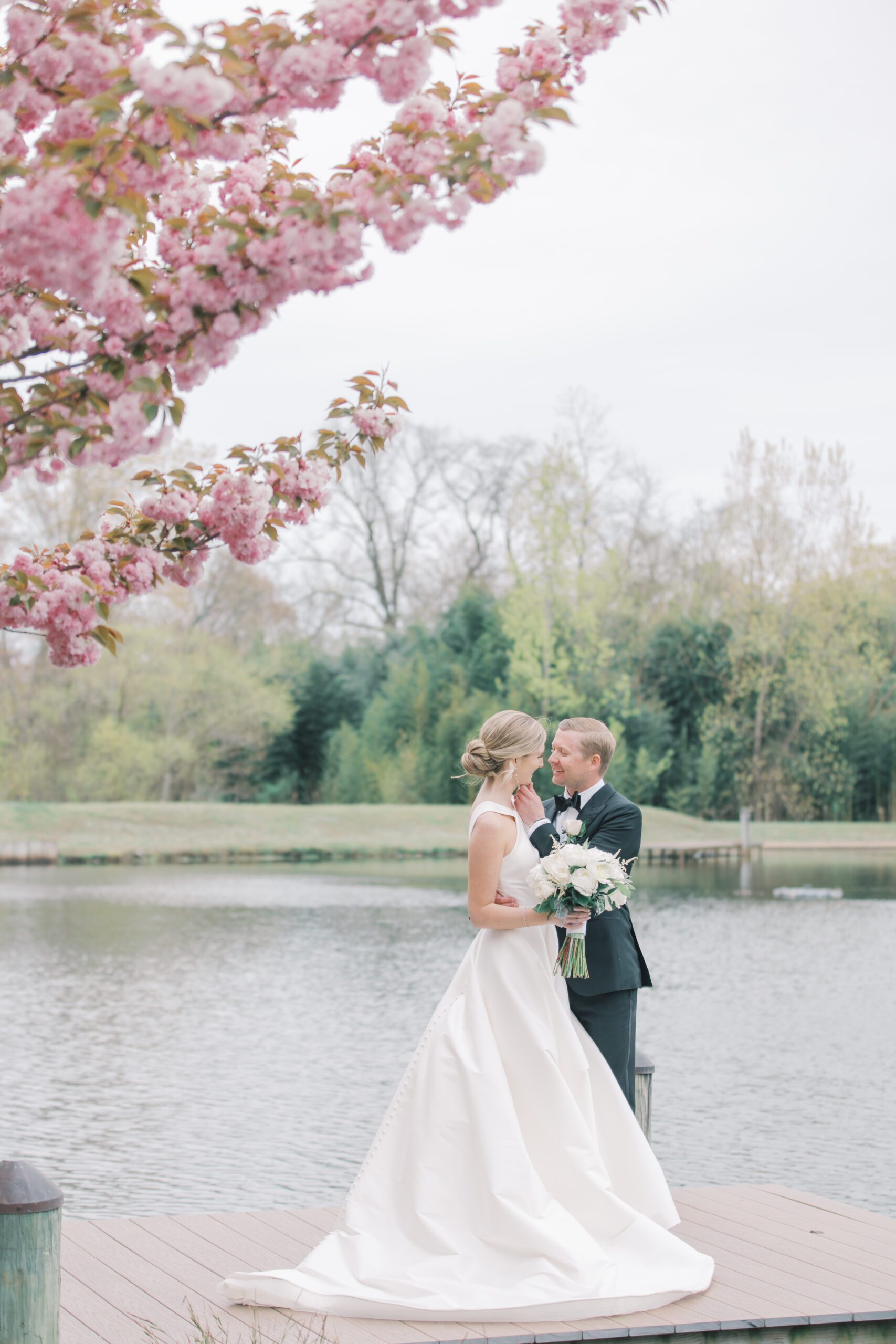 Bride and Groom on the dock at The Mill Lakeside Manor. 