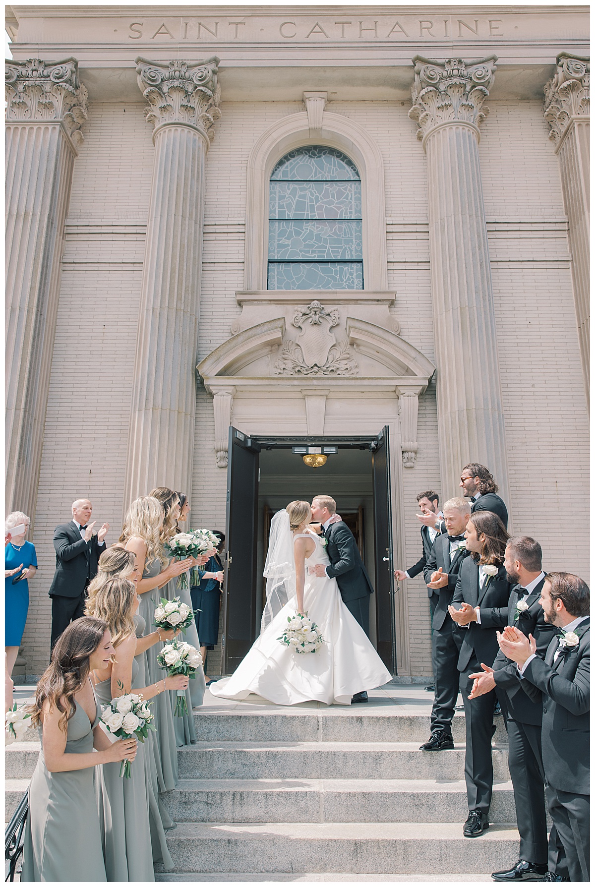 Bridal party cheers for bride + groom as they exit St. Catharine Church in Spring Lake. 