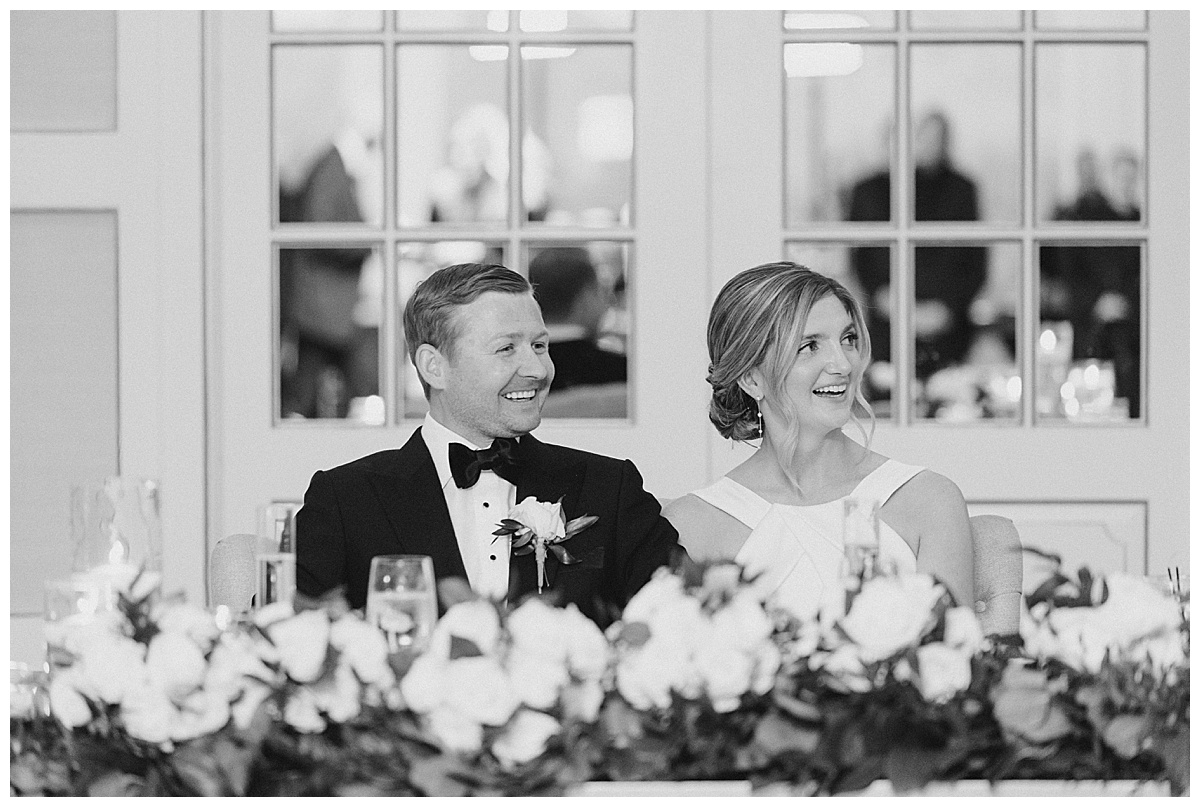 Bride and groom reaction to toasts during wedding reception at The Mill Lakeside Manor. 