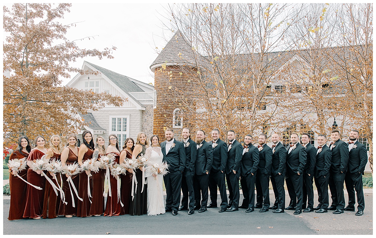 Large bridal party stands in front of the silo at The Ryland Inn in Whitehouse Station.