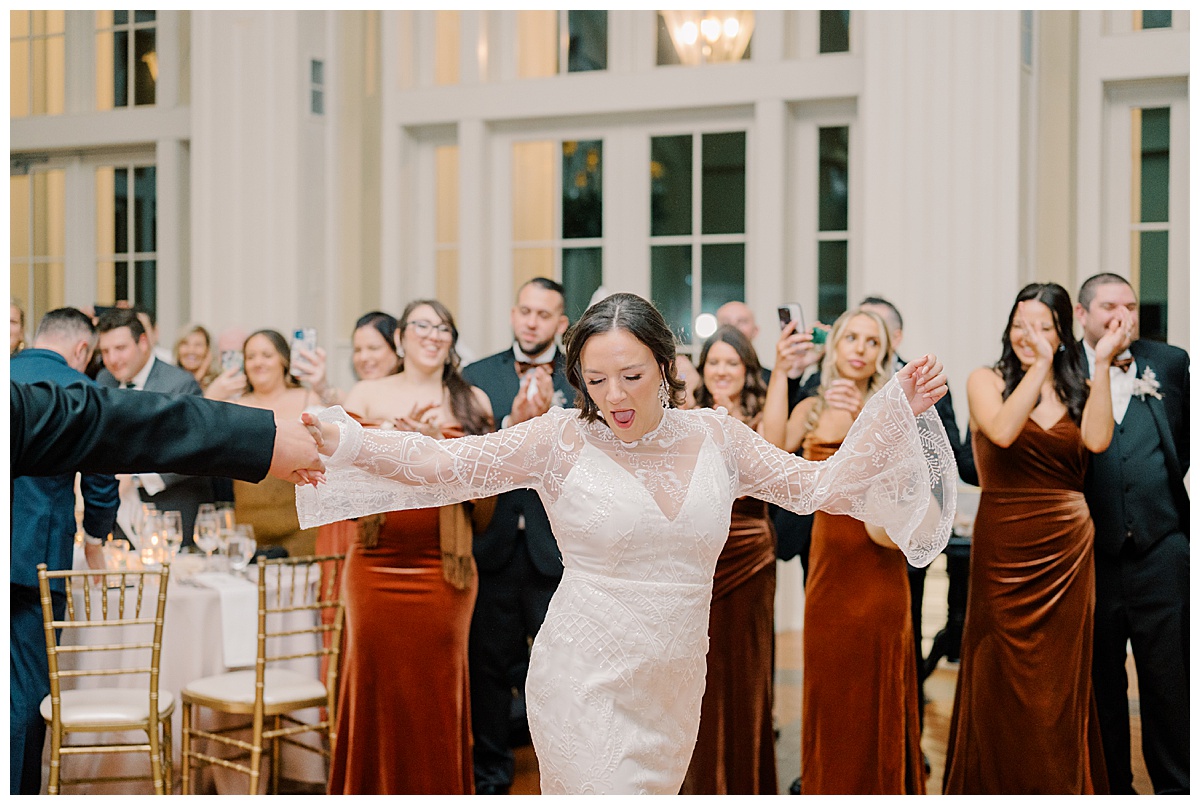 Bride dances as she enters the grand ballroom. 