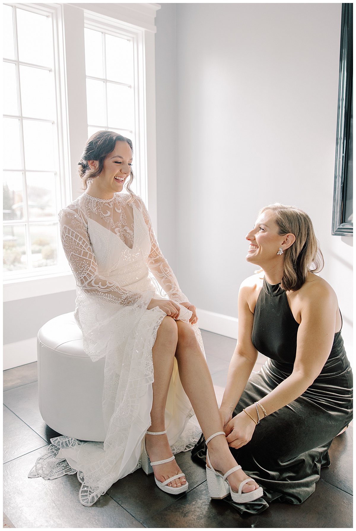 Maid of Honor helping bride with her shoes. 