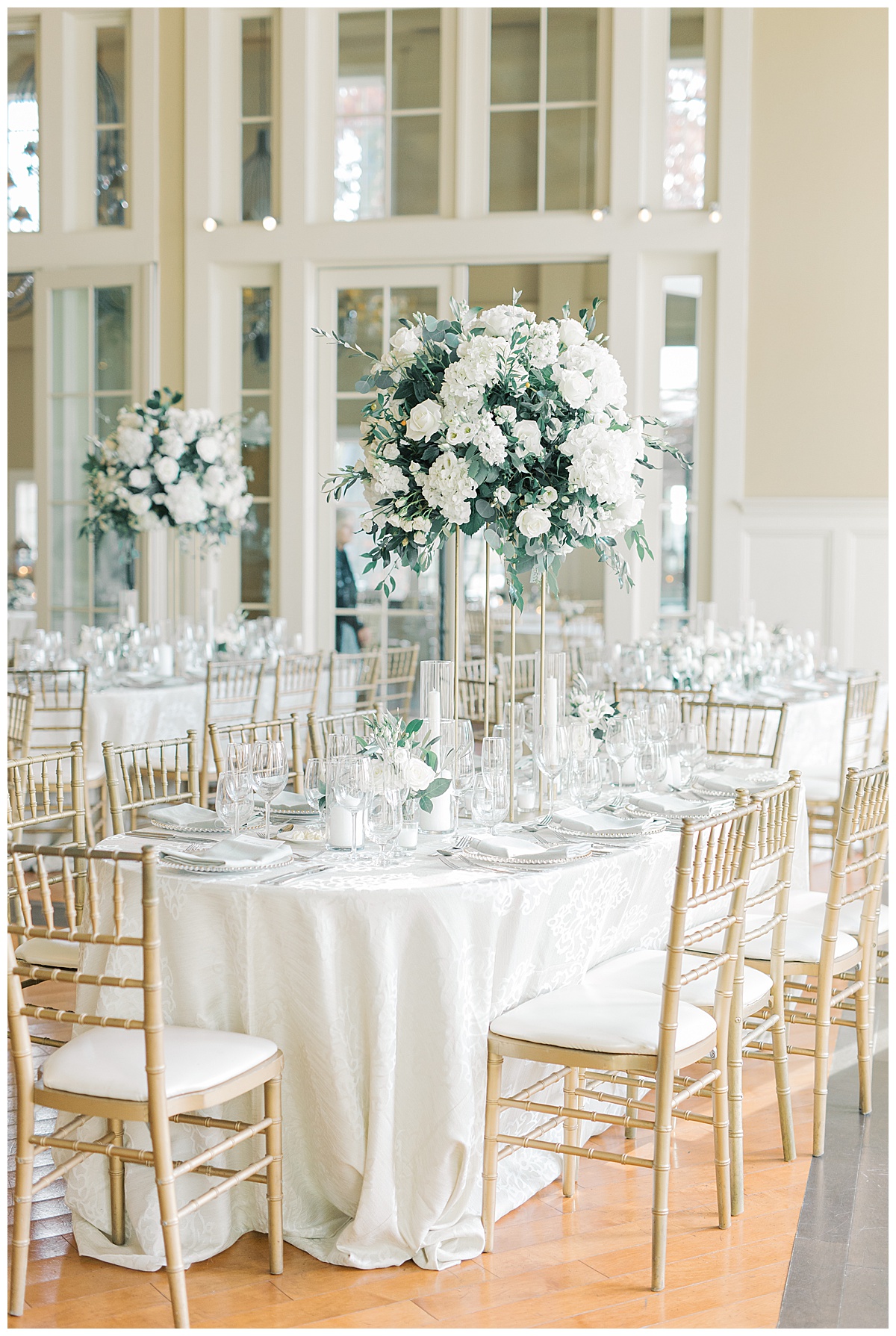 The Ryland Inn grand ballroom reception with white and green florals. 