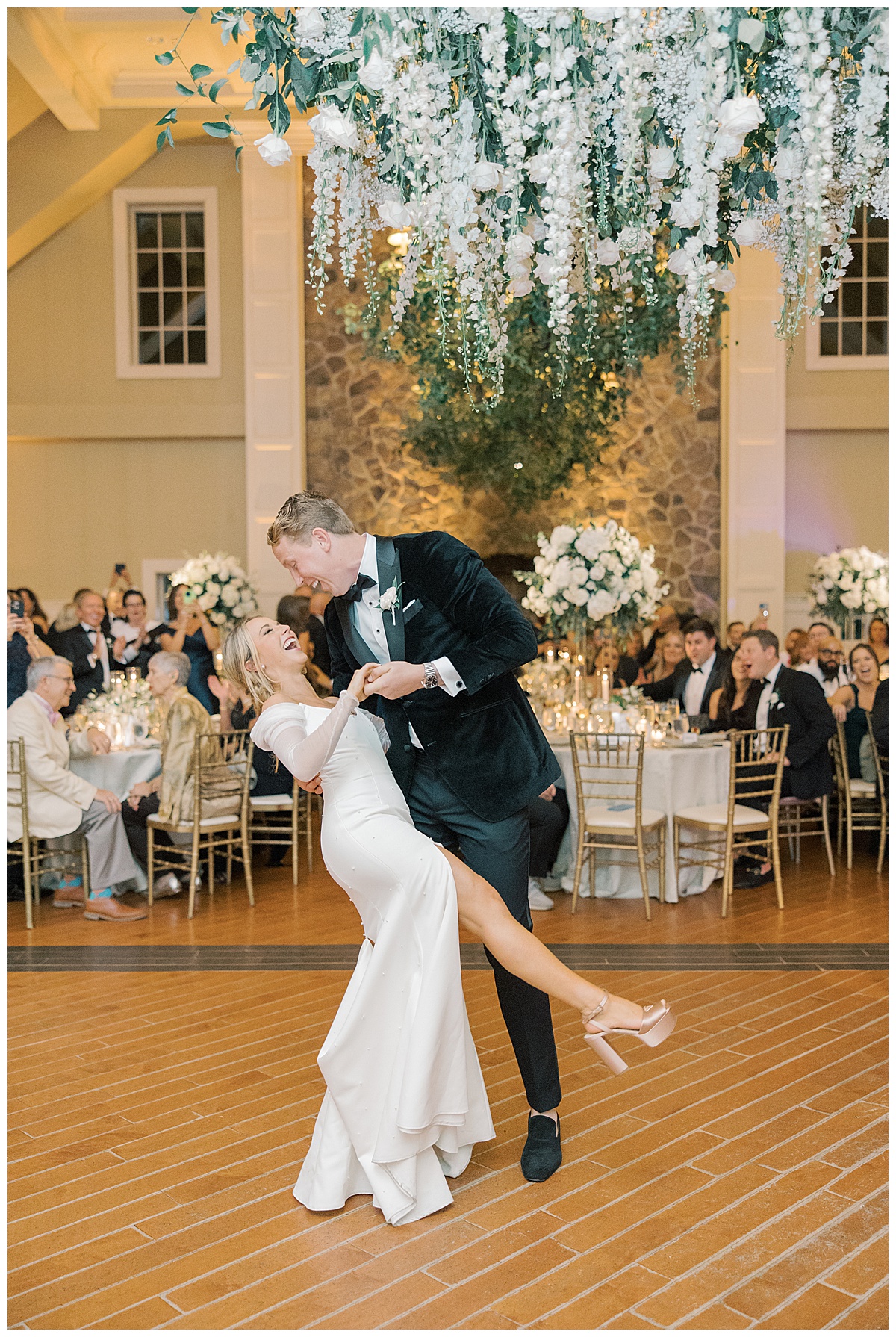 Bride and groom share their first dance together at The Ryland Inn as the guests cheer and clap. 