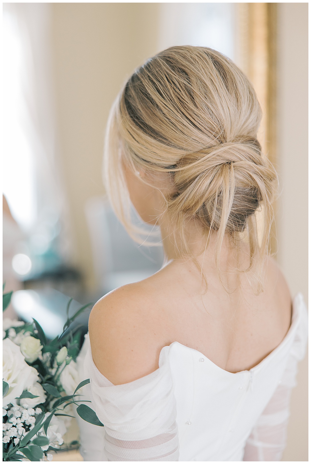 Bride with low messy bun on wedding day at The Ryland Inn. 