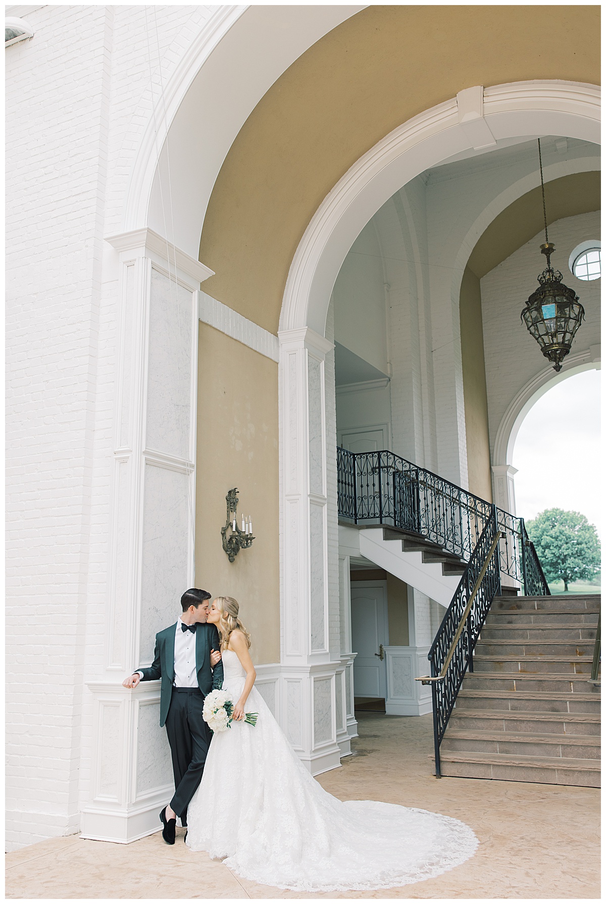 bride and groom near archway stair case at Trump National Golf Bedminster