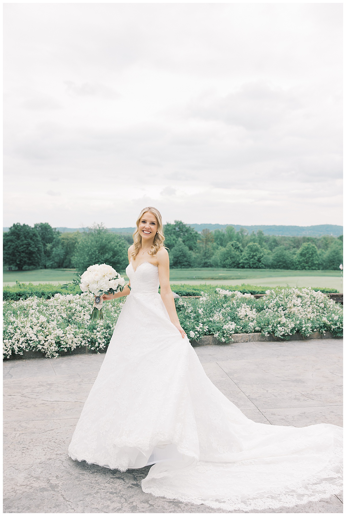 bride with the golf course behind her in lace gown at Trump National Golf Bedminster