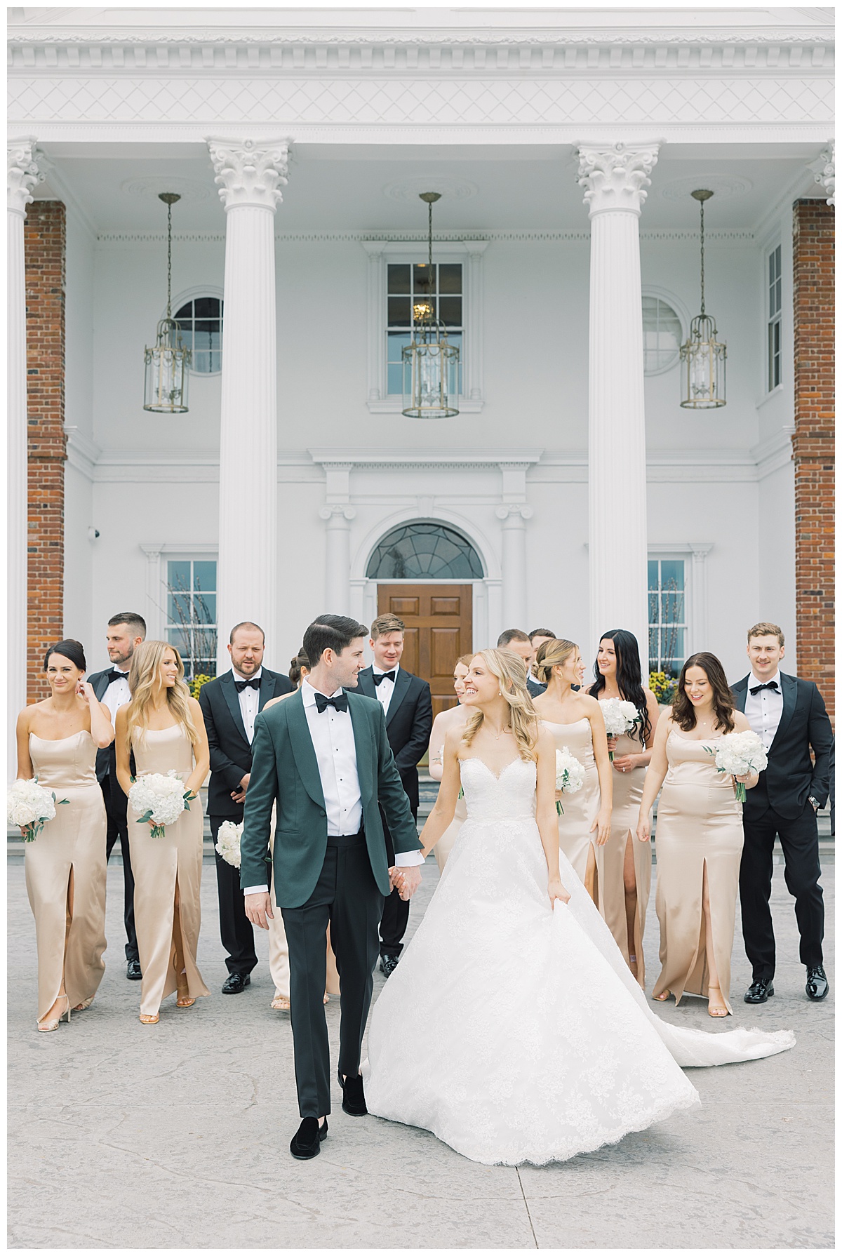 bride and groom walking with bridal party in black tuxedos and champagne silk gowns 