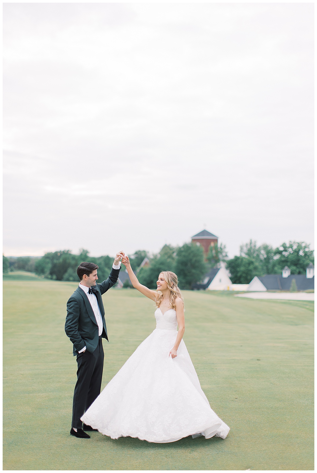 groom twirls bride on golf course 