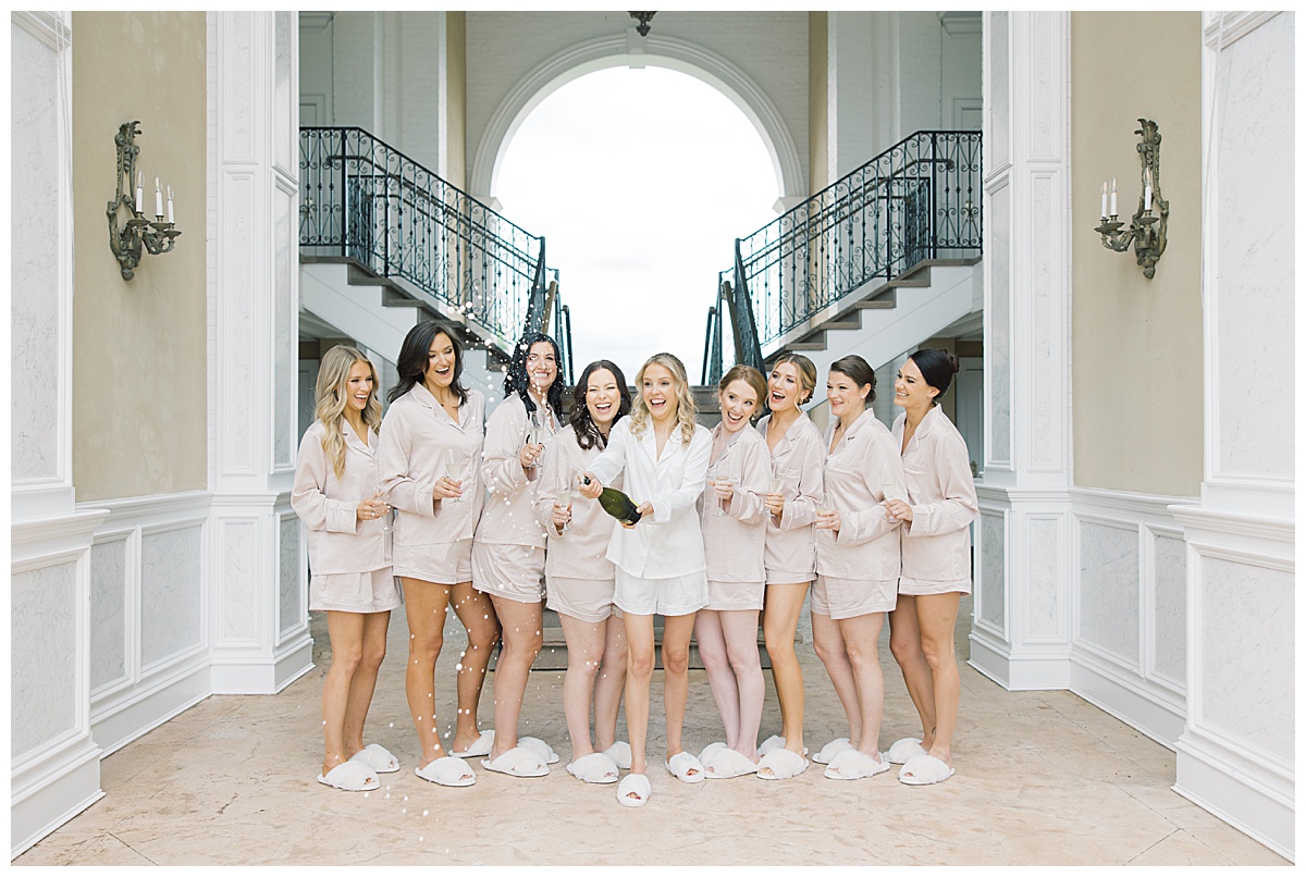 bride and bridesmaids popping champagne at trump national golf Bedminster 
