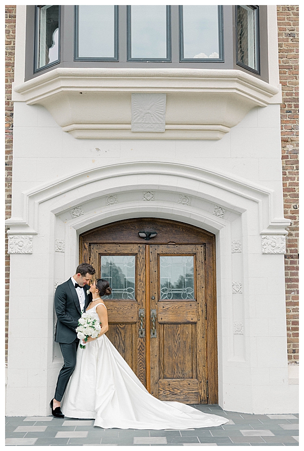 Bride and groom with a classic building as their backdrop at their NJ wedding
