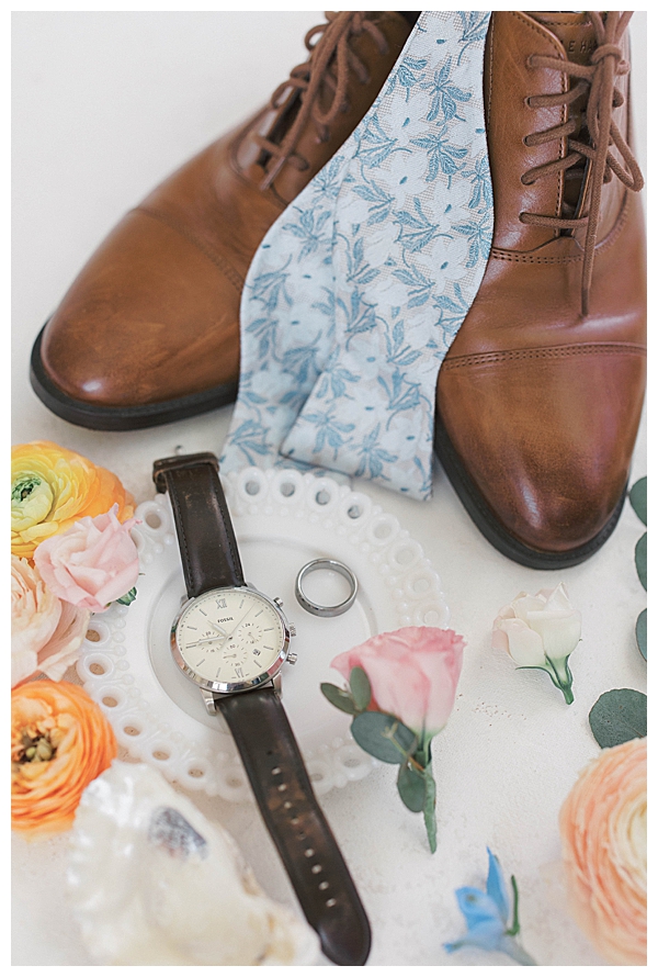 Groom adjusting tie at coastal NJ wedding venue