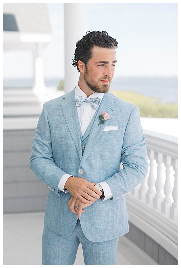 Candid groom getting ready photos at waterfront wedding venue