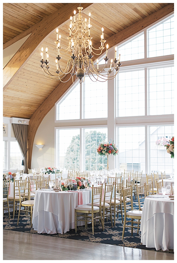 Reception decor with candles and florals at seaside venue